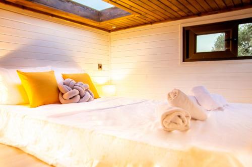 a bedroom with a bed with towels on it at Tiny House Framed by Nature near Sea in Karaburun in Izmir