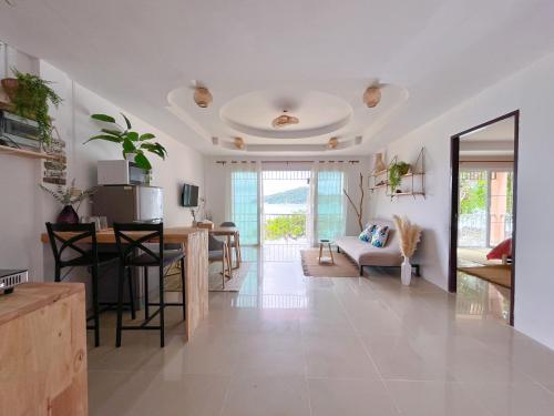 a living room with a kitchen and a dining room at At The Beach Apartments in Panwa Beach