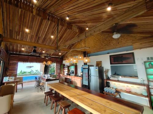 a large room with a long wooden table and chairs at 89 Villas in El Nido