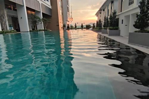 a swimming pool in the middle of a building at H&W Sunway Onsen Suite Tambun Sunway City Ipoh in Ipoh