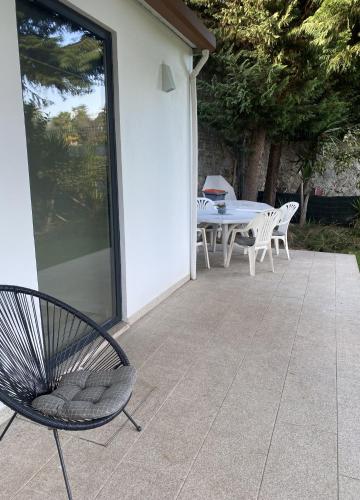 a patio with a table and chairs on a patio at Casa do Lago in Amares