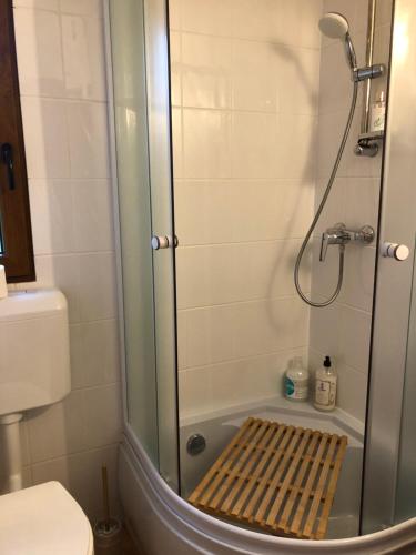 a bathroom with a shower with a bench in the tub at Cabana Wonderland in Păuliş