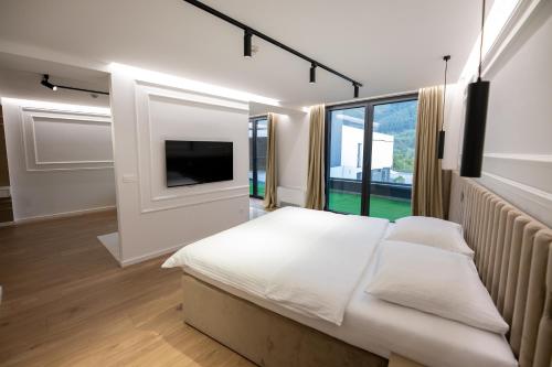 a bedroom with a bed and a large window at Hotel IN in Žepče