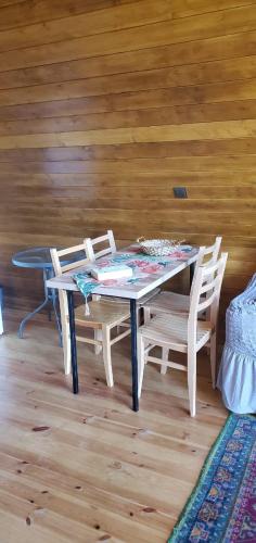 OniにあるSeva Villa in Rachaの木製の壁の客室で、テーブルと椅子が備わります。