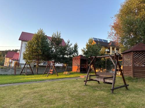 a park with a swing set in the grass at Готель Едельвейс in Skhidnitsa