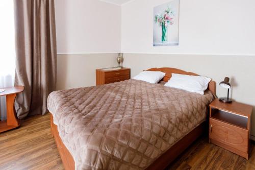a bedroom with a bed and a table with a vase at Готель Едельвейс in Skhidnitsa