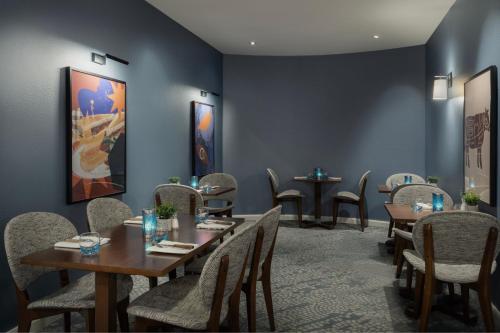 a restaurant with tables and chairs in a room at Delta Hotels by Marriott Peterborough in Peterborough