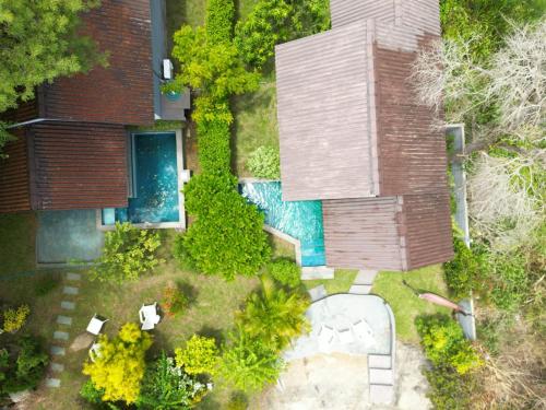 an overhead view of a backyard with a swimming pool at Hidden Lake Cottages Sigiriya in Sigiriya