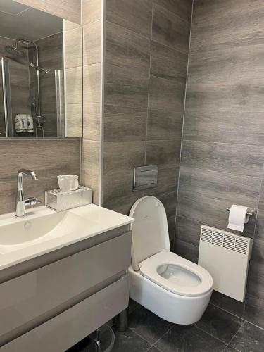 a bathroom with a toilet and a sink and a mirror at Jerusalem Center in Jerusalem