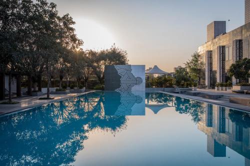 a swimming pool in front of a building at Karma Chalets in Gurgaon
