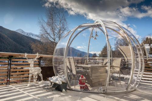 a dome tent on a deck with a fire hydrant at B&B Alpen Suite Ponte di Legno in Ponte di Legno