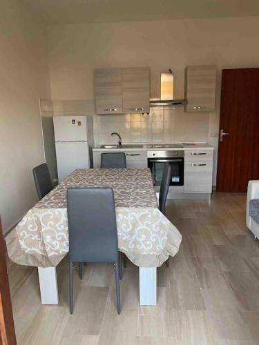 a kitchen with a table and chairs and a kitchen with at NF appartamenti in SantʼEufemia Lamezia