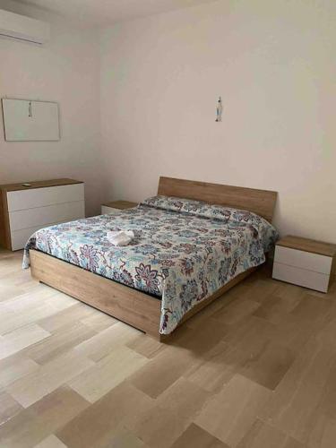 a bedroom with a bed and two night stands at NF appartamenti in SantʼEufemia Lamezia