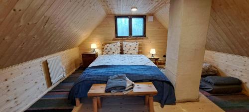 a bedroom with a bed in a wooden house at Raistiko sauna cabin / Raistiko saunamaja 