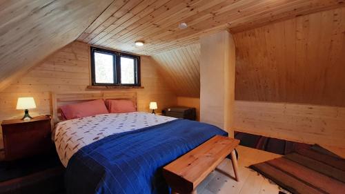 a bedroom with a bed in a wooden cabin at Raistiko sauna cabin / Raistiko saunamaja 