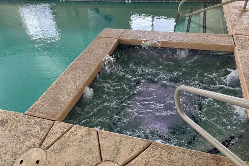 a swimming pool with water in the middle at Travelodge by Wyndham Holbrook in Holbrook