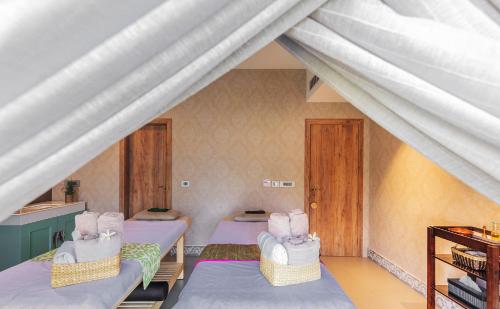a room with two beds in a room at Karma Chalets in Gurgaon