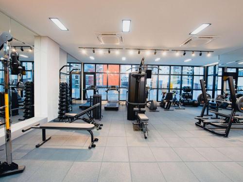 a gym with several treadmills and machines at ibis Curitiba Shopping in Curitiba