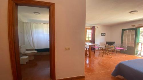 a room with a bed and a bathroom with a table at Apartamento Nelly S4 in Valle Gran Rey