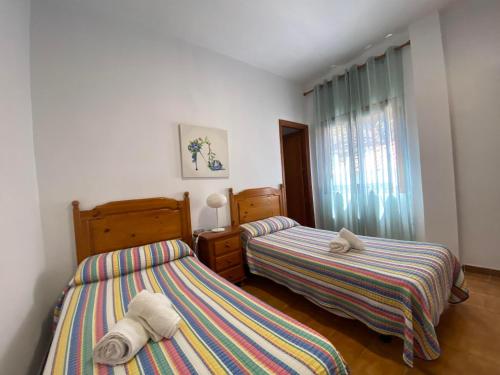 a bedroom with two beds and a window at Apartamento Nelly A2 in Valle Gran Rey
