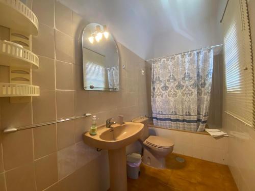 a bathroom with a sink and a toilet and a mirror at Apartamento Nelly A2 in Valle Gran Rey