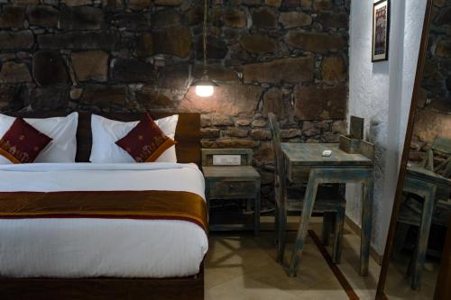 a hotel room with two beds and a table at Wada1 in Aihole