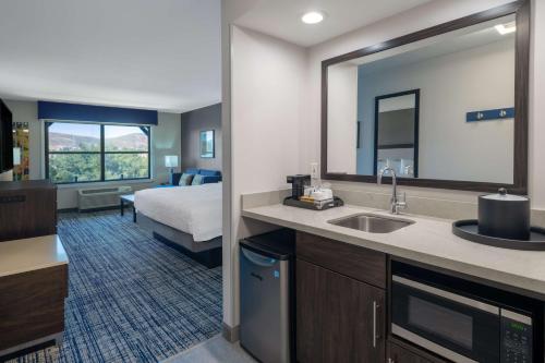 a hotel room with a sink and a bedroom at Hampton Inn & Suites Agoura Hills in Agoura Hills