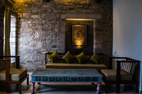a living room with a couch and two chairs at Wada1 in Aihole