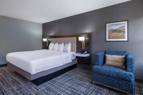 a hotel room with a bed and a chair at Hampton Inn & Suites Agoura Hills in Agoura Hills