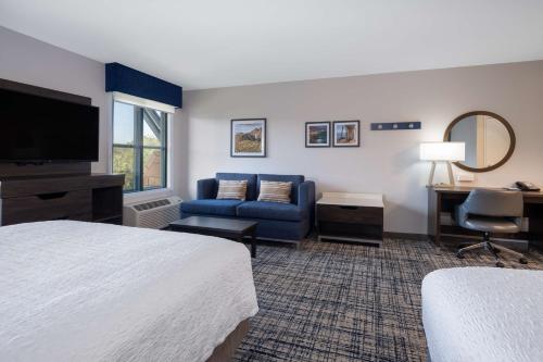 a hotel room with a bed and a couch at Hampton Inn & Suites Agoura Hills in Agoura Hills