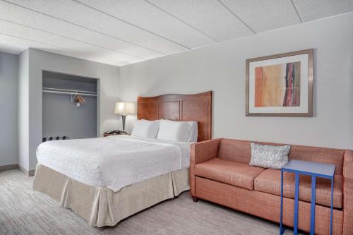 a hotel room with a bed and a couch at Hampton Inn Baltimore/White Marsh in White Marsh