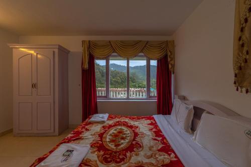 a bedroom with a bed with a plate on it at Fortune Retreats in Ooty