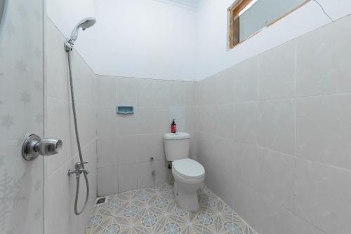 a bathroom with a toilet and a shower at RedDoorz near Ciletuh Sukabumi in Cilowa