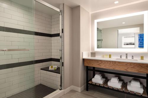 a bathroom with a sink and a shower at DoubleTree by Hilton Canton Downtown in Canton
