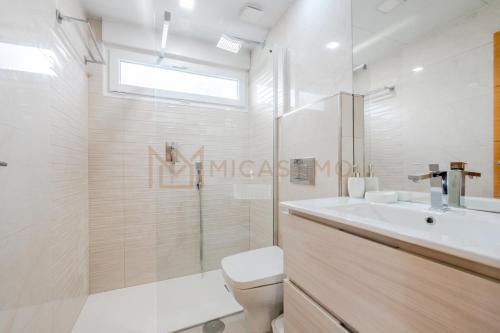 a bathroom with a toilet and a sink and a shower at Four Bedroom Mimosas Villa With A Private Pool in Atamaría