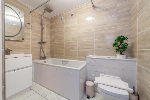 a bathroom with a white toilet and a sink at Do not use in London