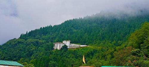 a building on the side of a mountain at Voyage Glenz Resort in Pakyong