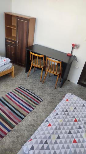 a living room with a table and chairs and a rug at Nároďák Jaroměř ,UBYTOVÁNÍ in Jaroměř