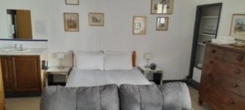 a bedroom with a bed and a couch at The Old Court House Guest House in Ross on Wye