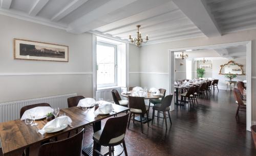 a restaurant with tables and chairs in a room at The French Partridge, in Northampton