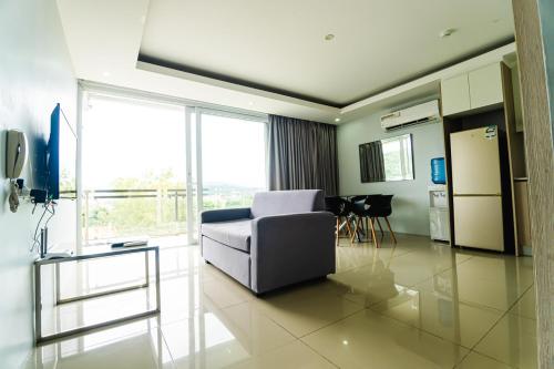 a living room with a couch and a table at Chequers Suites Subic Bay in Olongapo