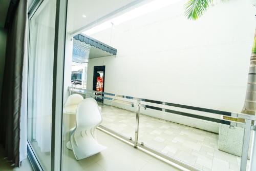 a hallway with two white chairs in a building at Chequers Suites Subic Bay in Olongapo