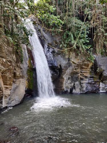 a waterfall in the middle of a body of water at FARILA LODGE in Kelimutu