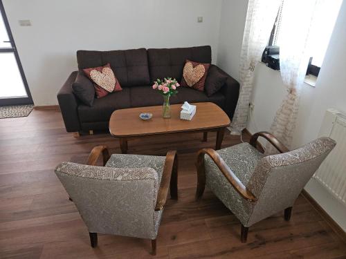 a living room with a couch and a table and chairs at Vinohradnícky domček in Vrádište