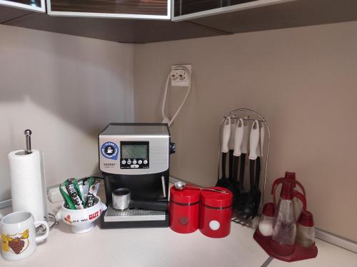 a kitchen counter with a coffee maker and utensils at Етаж от къща - Нощувки Ками in Pleven