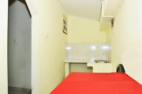 a kitchen with a red carpet and a sink at Blumarine Guest House in Negombo