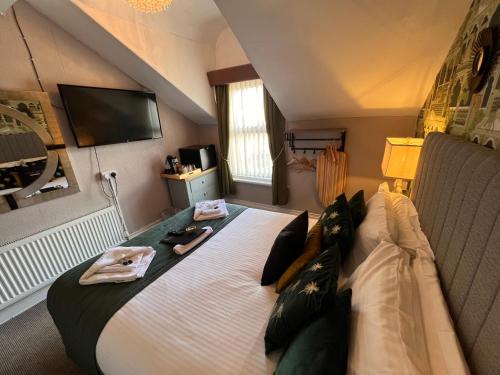 a bedroom with a large bed with towels on it at Delovely Hotel in Blackpool