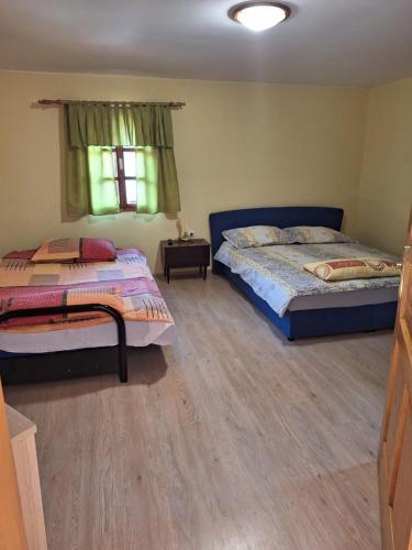 1 dormitorio con 2 camas y ventana en Apartment Pečarič, en Metlika