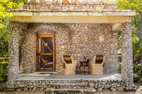 a small stone house with a table and two chairs at Korta Escape- A Heritage Resort in Jawai in Korta