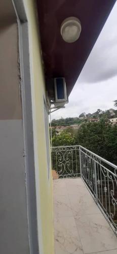 a balcony of a house with a television on it at MediSweet Apartments Meublés in Yaoundé